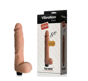 vibrador realístico com escroto. Ele é da cor da pele. É mostrado fora da caixa. E ele também apresentado na caixa. 