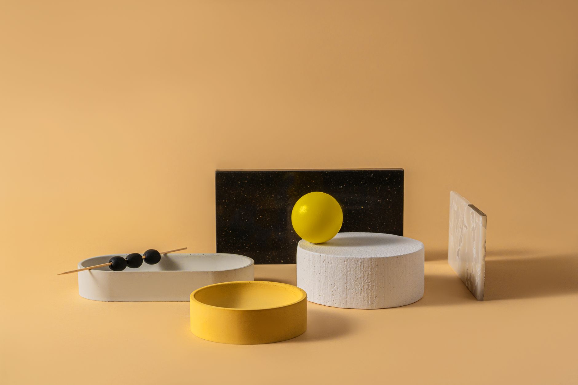 Uma foto de estúdio de uma composição geométrica criativa minimalista apresentando várias formas e cores sobre um fundo amarelo